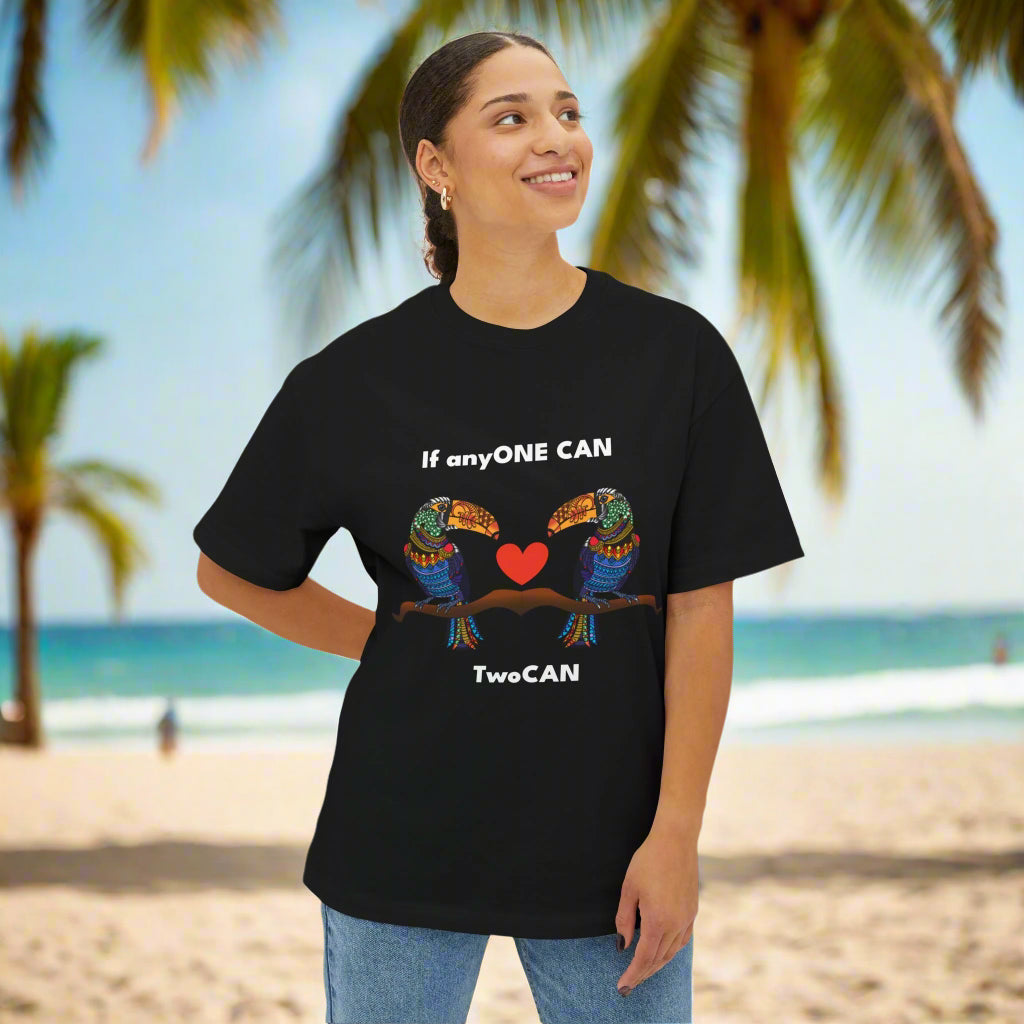 Person wearing a black t-shirt with colorful bird design and text on a white background